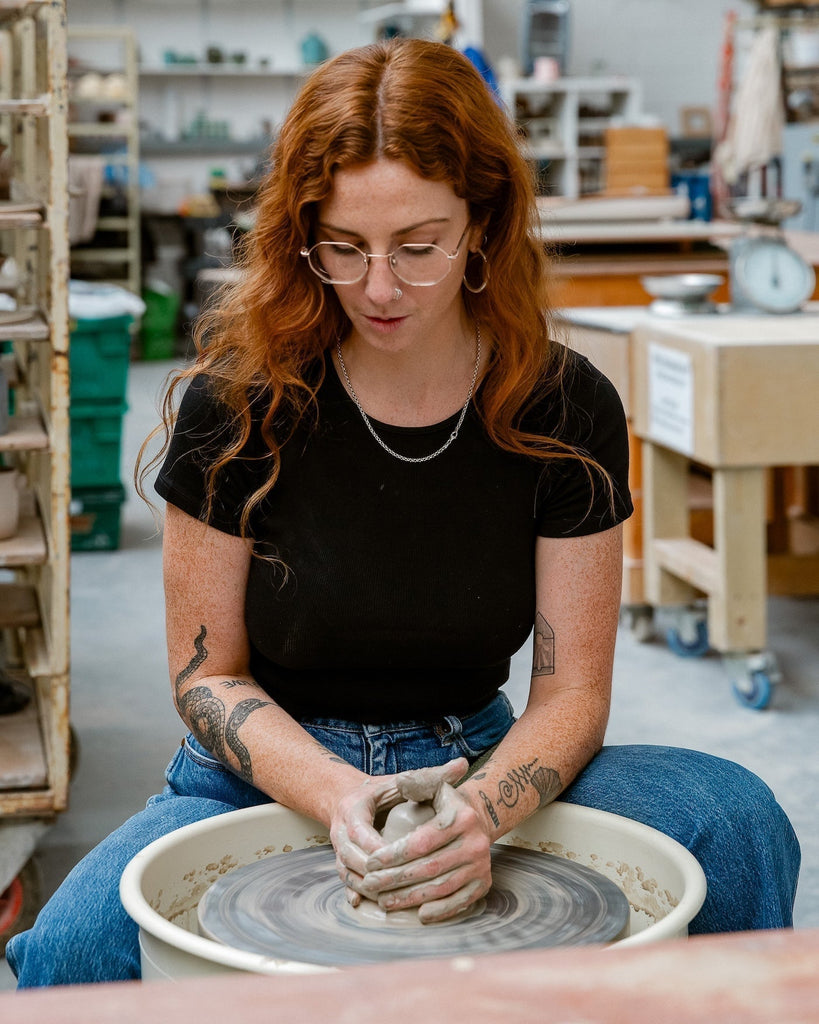 Scree Ceramics at the wheel at Turning Earth In Production.