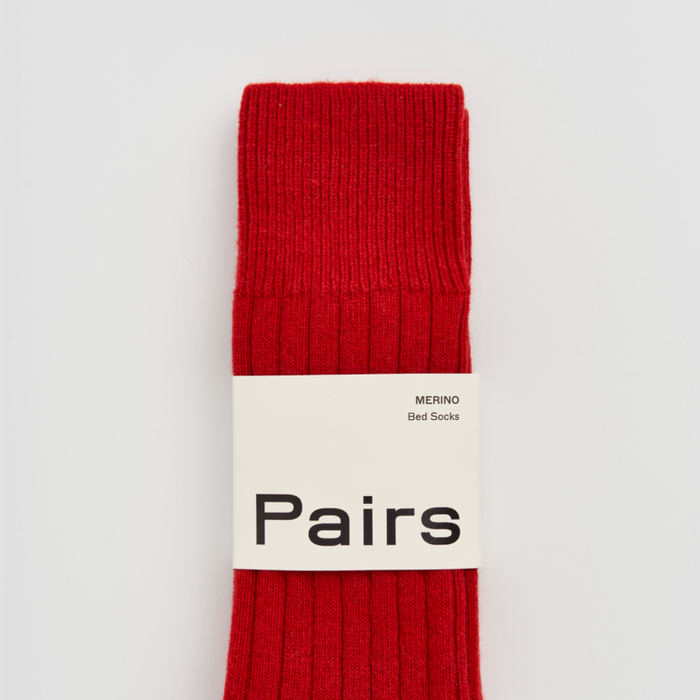 Red sock with 'Pairs' branding on a white background. Pairs Socks | Shop Fodder