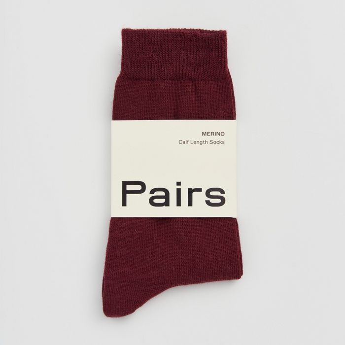 Maroon sock with a white label displaying 'Pairs' on a light gray background. Pairs Socks | Shop Fodder