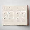 Calendar with '2027' printed on a beige background. 2026 Planner | Kinshipped | Shop Fodder