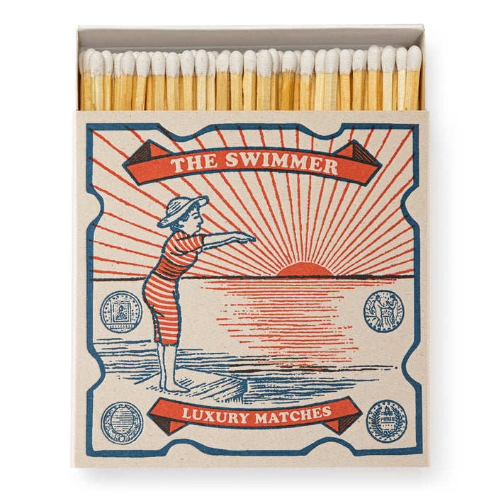 Matchbox labeled 'The Swimmer' with a design of a swimmer and sunset. - Matches | Archivist Gallery | Shop Fodder