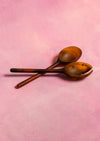 Two wooden spoons on a pink background. Maegen | Shop Fodder
