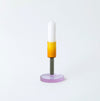 Coloured glass a candlestick holder on white background. 