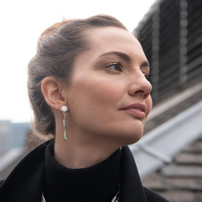 Woman wearing earrings with a blurred background.  | Scarlett Cohen French | Shop Fodder