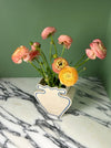 cream vase with blue outline pattern and pinky yellow flowers