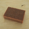 red soap on a table with the word Evermore embossed on the soap. 