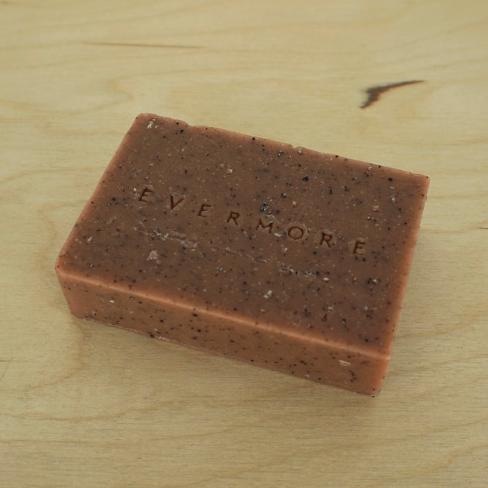 red soap on a table with the word Evermore embossed on the soap. 