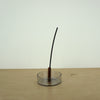 a charcoal incense stick from Evermore London in a glass incense holder by Block Design. 