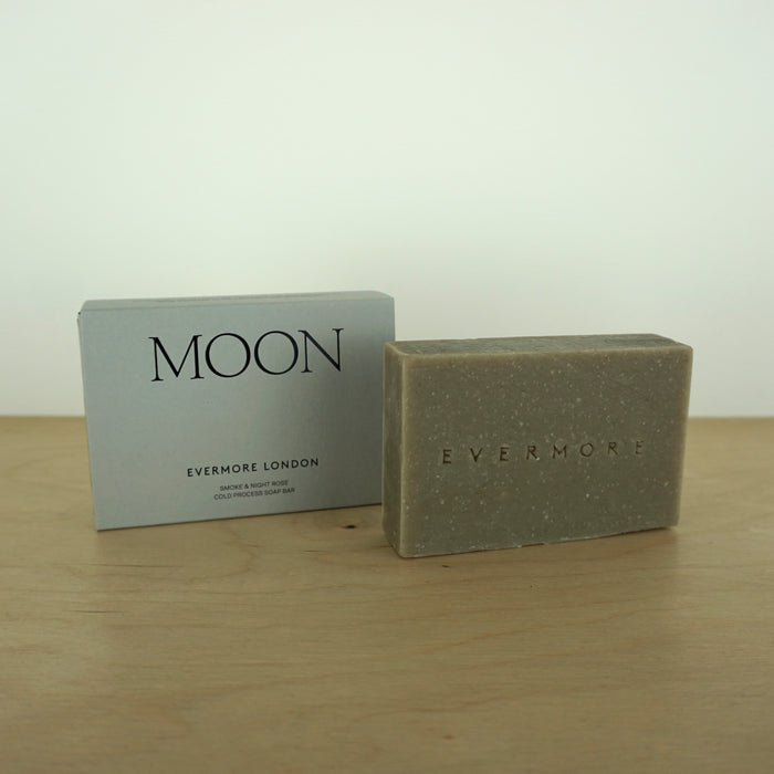 a bar of soap and a box on a wooden table by Evermove London. 