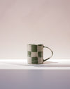 Checkered mug on a gradient background. Fern Taylor Nerikomi Ceramics. Fodder