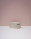 White ceramic butter dish with saucer on a light pink background. Brutes Ceramics | Inlay Butter Dish | Fodder