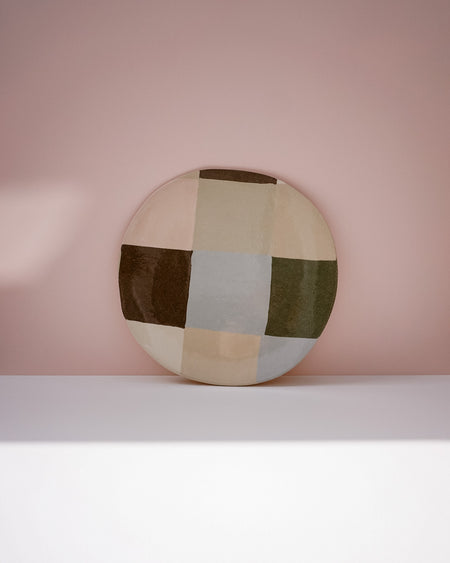 Round ceramic plate with a geometric pattern on a pink background. Patchwork Platter | Brutes London | Handmade Ceramics | Fodder
