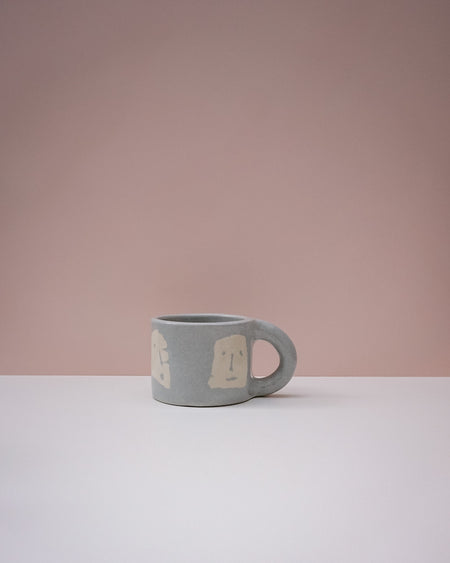 Gray mug with a handle on a white surface and pink background. Portrait Mug | Brutes London | Handmade Ceramics | Fodder