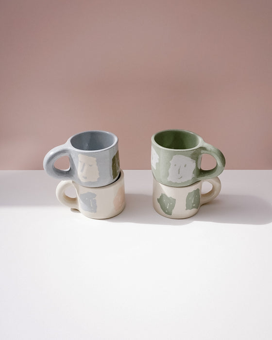 Two ceramic mugs with abstract designs on a light pink background. Portrait Mug | Brutes London | Handmade Ceramics | Fodder