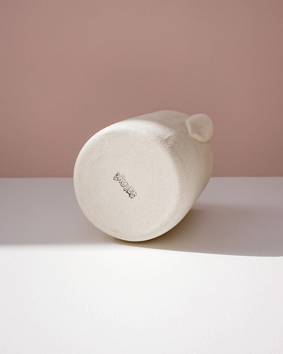 White cylindrical product with 'BRUTES' branding on a light pink background. Handmade Stoneware 500ml Carafe by BRUTES Ceramics | Shop Fodder