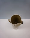 Ceramic pitcher on a white surface with a grey background. Water jug by Cara Guthrie - iron wash dots - handmade stoneware - Fodder
