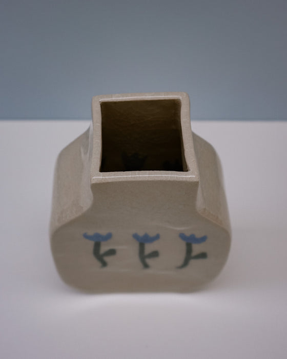 Ceramic vase with square base and rectangular top on a white surface with a light blue background. | Tulip Vase | Nerikomi | Fern Taylor | Shop Fodder
