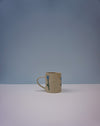 Ceramic mug with floral design on a gradient blue and grey background. Tulip Mug | Nerikomi | Fern Taylor | Shop Fodder