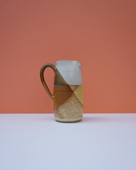 Ceramic pitcher with a geometric design on a peach background. Liz Vidal Ceramics | Shop Fodder