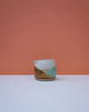 Ceramic pitcher with geometric design on a peach background. Liz Vidal Ceramics | Shop Fodder