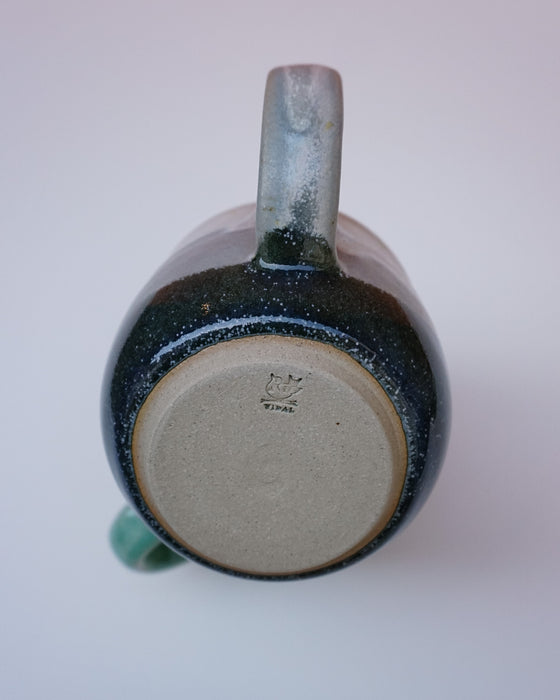 Ceramic mug with speckled design on a white background. Liz Vidal Ceramics | Shop Fodder
