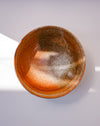 A handmade ceramic bowl with a textured, speckled glaze in earthy brown, orange, and beige tones, photographed from a top-down perspective on a light gray background. Morning Bowl | Scree Ceramics | Fodder