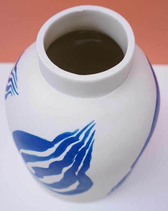 White ceramic vase with blue wave design on a white background. Sophie Alda | Handmade Ceramics | Shop Fodder