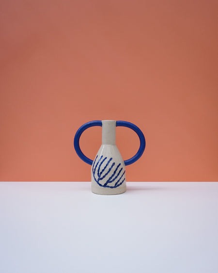 Ceramic vase with blue handles and abstract design on a peach background. Sophie Alda | Handmade Ceramics | Shop Fodder