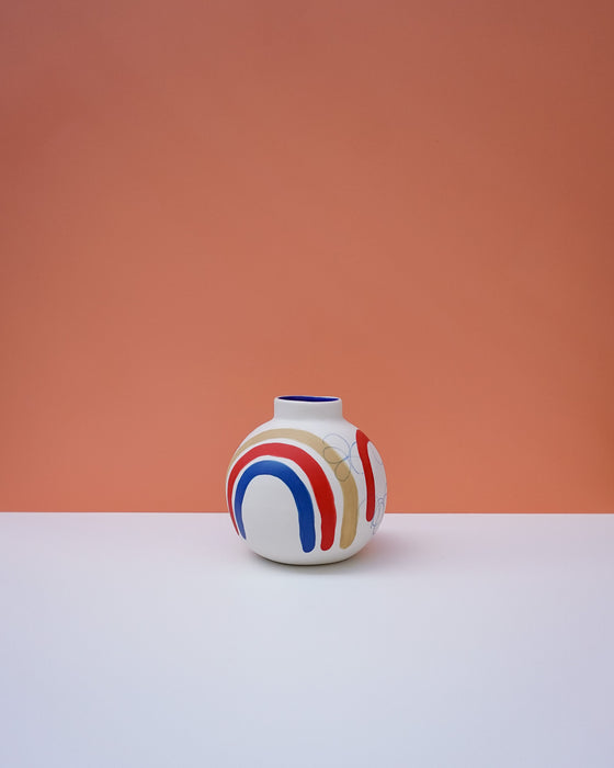 Round vase with colorful design on a peach background. Sophie Alda | Handmade Ceramics | Shop Fodder