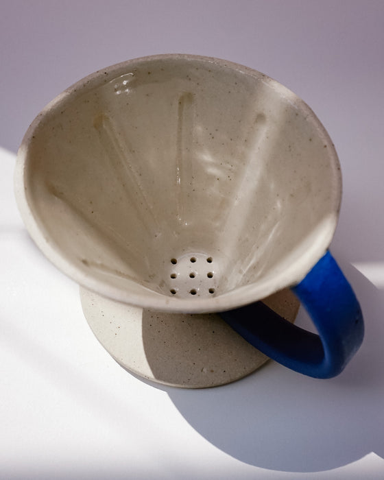 Ceramic coffee filter with blue handle on a white background. Sophie Alda | Handmade Ceramics | Shop Fodder