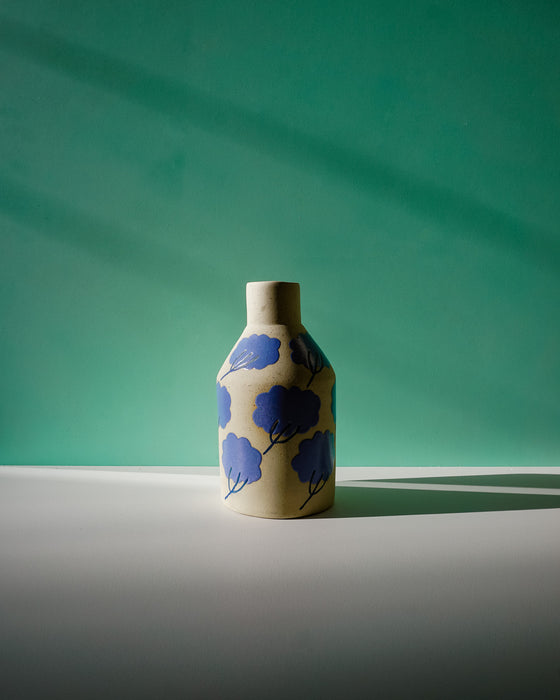 Ceramic vase with blue floral patterns on a green background. Sophie Alda | Handmade Ceramics | Shop Fodder