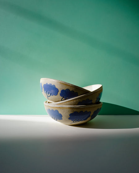 Two ceramic bowls with blue cloud patterns on a green and white background. Sophie Alda | Handmade Ceramics | Shop Fodder
