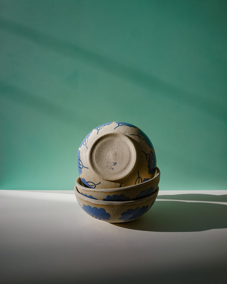 Stack of ceramic bowls with floral patterns on a green and gray background. Sophie Alda | Handmade Ceramics | Shop Fodder