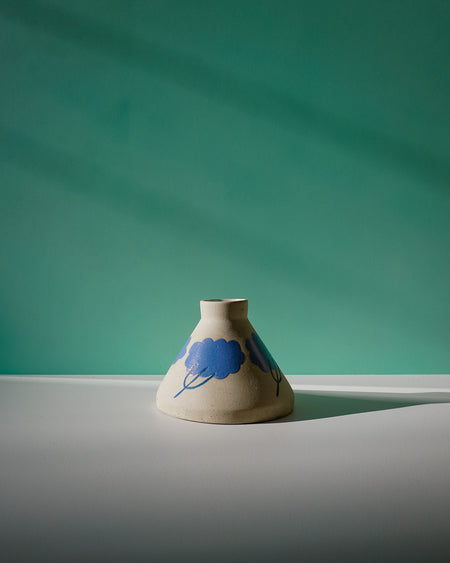 Ceramic vase with blue floral design on a green and gray background. Sophie Alda | Handmade Ceramics | Shop Fodder