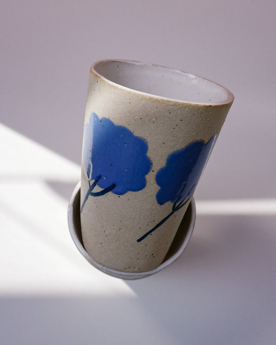 Ceramic cup with blue floral design on a light background. Sophie Alda | Handmade Ceramics | Shop Fodder