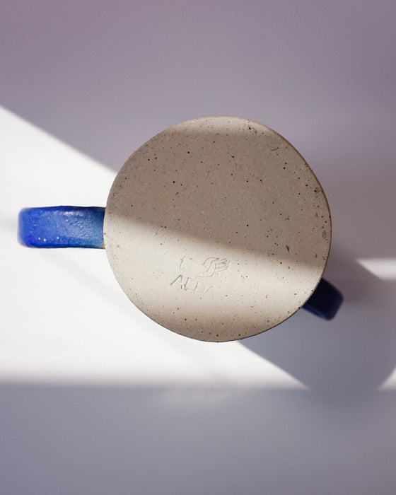 Ceramic pot with a blue handle on a white background. Sophie Alda | Handmade Ceramics | Shop Fodder