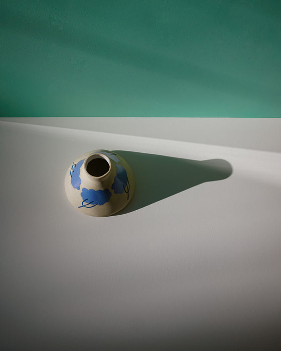 Ceramic vase with blue design on a white surface with teal background. Sophie Alda | Handmade Ceramics | Shop Fodder