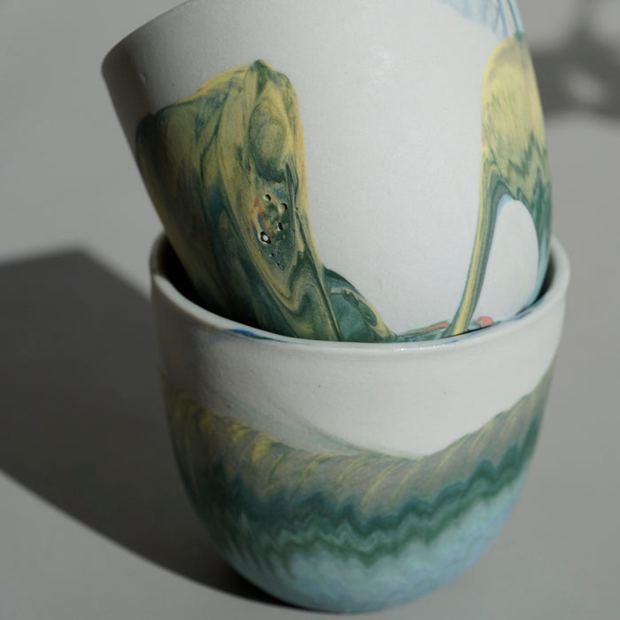close up detail of handmade marbled porcelain cups. 