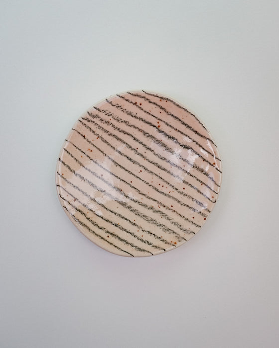 Round ceramic plate with striped pattern on a light gray background. Diddy Bowl | Jode Pankhurst | Shop Fodder