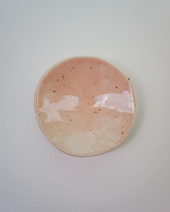 Round ceramic plate with a speckled design on a light gray background. Diddy Bowl | Jode Pankhurst | Shop Fodder