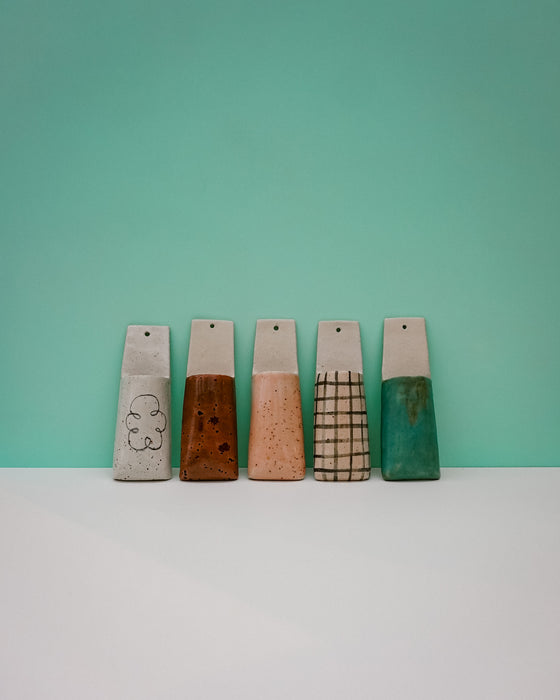 Five wooden blocks with different textures and colors on a teal background | Jode Pankhurst