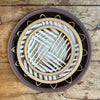 a stack of three plates on a wooden table taken from above. 