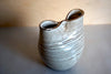 a vase with a squished neck to make two openings at the top. 
