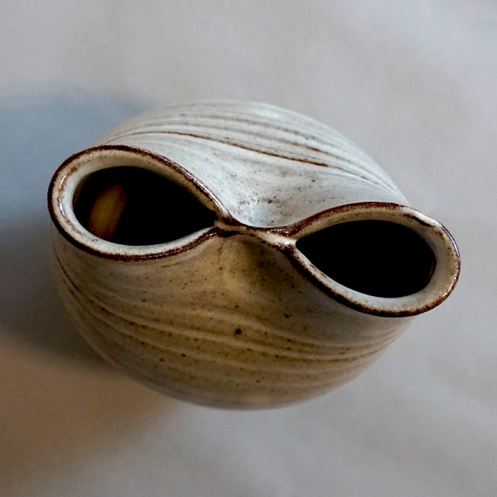 The top view of a vase that was squished to make two openings. 