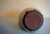 the base of a vase in red stoneware with the maker mark of Lily Pearmain. 