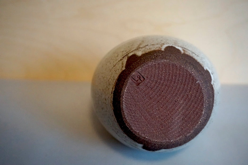 the base of a vase in red stoneware with the maker mark of Lily Pearmain. 