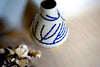 dried hydrangeas next to a porcelain vase with a hand painted blue pattern.  