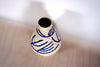  porcelain vase with a hand painted blue pattern.  