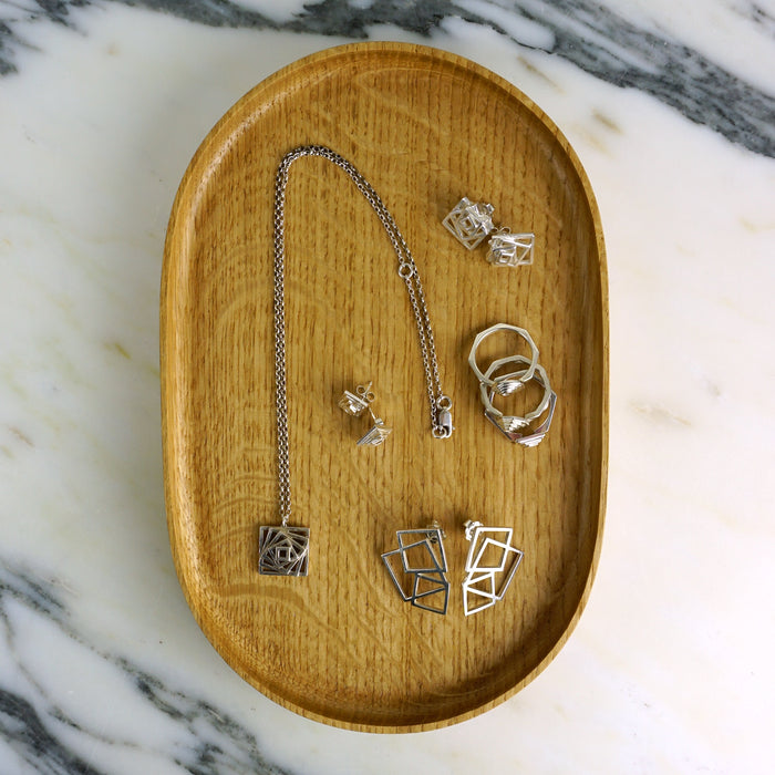 Wooden tray with silver jewelry on a marble surface | Scarlett French | Shop Fodder