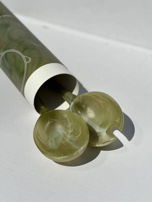 Two green marbled objects with a cylindrical container on a white background. Maegen | Shop Fodder